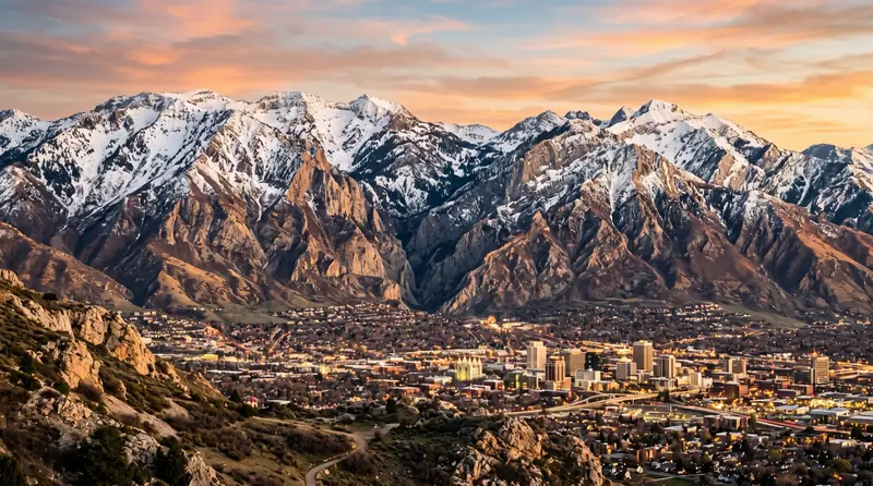 The rugged snow-capped Wasatch mountains towering above Salt Lake City at golden hour